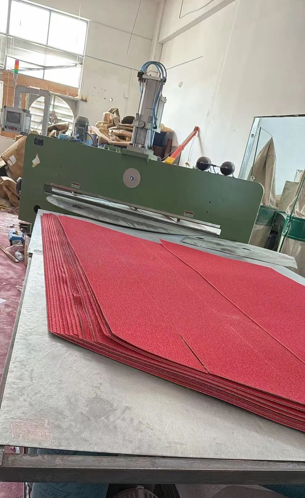 Custom-cut coated abrasive shapes beside converting equipment